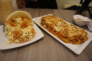 Arepa with Scramble tofu and vegan sausage; stuffed plantain  at Marvelous Vegan Plant Power Food in Bogota