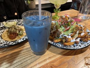 From left: barbacoa taco, butterfly pea flower horchata, asada fries  at Penelope's Vegan Taqueria in Chicago