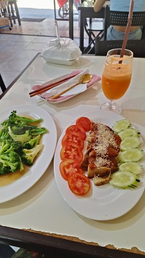 Fried Duck with Peanut sauce and fried broccoli. at Reunion Cafe in Vientiane