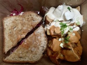 Rueben with potatoes upgrade, and both the mild almond and the cashew chipotle sauces  at cafegSC in Santa Cruz