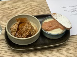 Dark chocolate & tonka bean ganache, passion fruit, sesame brittle.  Lemon posset, rhubarb compote, biscotti  at Roundhill Restaurant in Brighton
