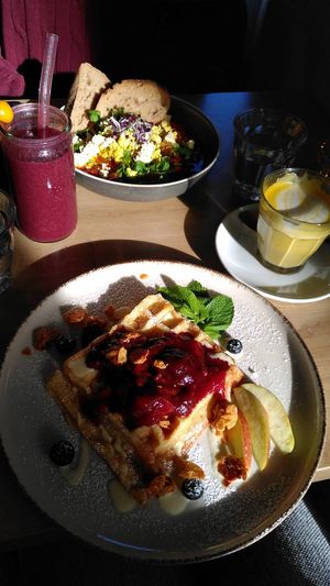 Foreground: belgian waffle with plum sauce and other toppings, background: Shakshuka (?) at Easy Peasy in Berlin