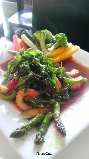 dragon shrimp: soy shrimp sauteed with red curry sauce and asparagus, topped with crispy basil leaves at Charm Vegan in South Pasadena