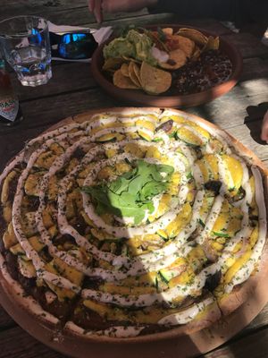 Creamy mushroom pizza $26 (large) and nachos $21 at Mandala & Co in Mermaid Beach