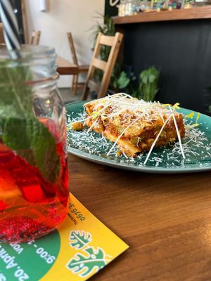asparagus lasagna with cheese topping and a pomegranate fizzy drink with fresh fruit at Green Taste in Innsbruck