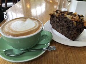 Soy latte and vegan chocolate date apricot cake at The Good Earth Cafe in Dunedin