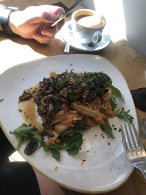 Tofu-kimchi toast and flat white coffee  at Steel Vintage Bikes Café in Berlin