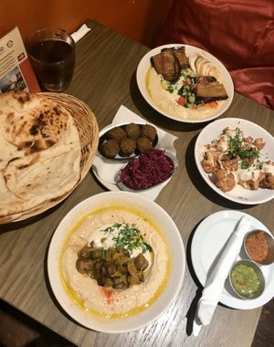 Selection of hummus, bread, falafel, cabbage, and cauliflower at Hummus Bar - Oktober in Budapest
