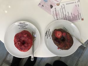 Raspberry donut (moist, very sweet) and chocolate glaze donut (rather dry, not so sweet). both are vegan  at La Donuteria in Olomouc