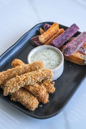 Fish and Chips - Crispy fish fingers and sweet potato fries serve with Tartar Sauce. at Sauce Tree Kuta in Kuta