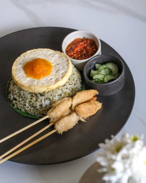 Pesto Fried Rice - Pesto Fried Rice with Satay Skewers and Tofu Egg, serve with Homemade Chilli and Pickles. at Sauce Tree Kuta in Kuta