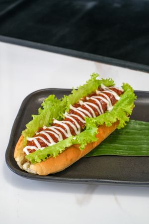 Beandog - Sausage, Caramelized Onion, Lettuce with Russian Dressing, BBQ Sauce and Mayo. at Sauce Tree Kuta in Kuta