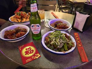 Korean wings and blackbean udon noodles.  In the background spiced tofu fries and another portion of wings. at Hello Oriental in Manchester