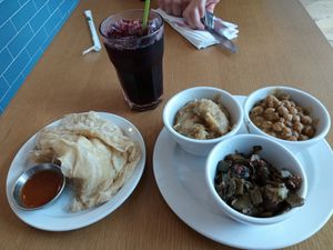 "Buss up shut" bread with sides of stewed eggplant, curried chickpeas, and okra, plus a delicious glass of sorrel to drink. at ShadoBeni in Pittsburgh