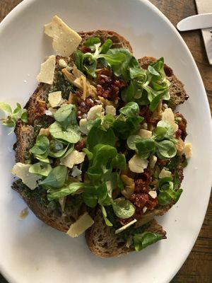 Vegan parmigiana shavings on top   at Distrito Vegano Invernadero in Madrid