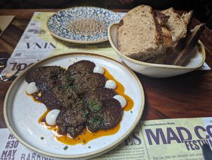 Vegan sausage with sourdough bread at Distrito Vegano Invernadero in Madrid