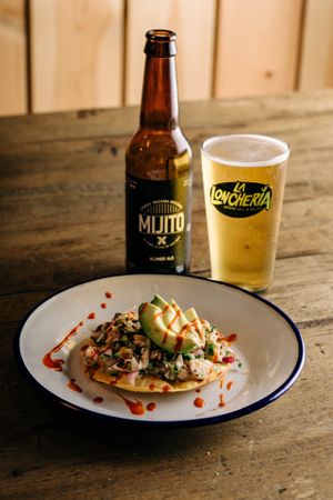 “TOSTADA DE CEVICHE” 
Mexican-style ceviche made with fried tortilla, banana blossom meat, marinated with “Leche de tigre”, onion, avocado, cilantro sprouts and a dash of  at La Loncheria Bcn in Barcelona
