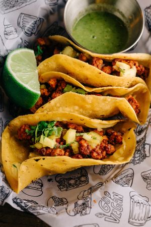 Mexican tacos made with fresh corn tortilla, textured soy marinated in a secret sauce, pineapple, red onion and coriander on top, accompanied with a spicy green sauce and lime 😍 at La Loncheria Bcn in Barcelona