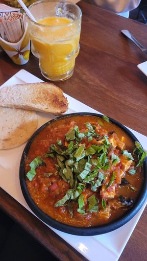 Tofu in tomato sauce with bread and arepa at Orígenes Café in Bogota