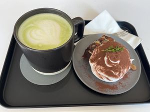 Matcha latte with oat milk and chocolate brownie. The cream on top was divine!   at Nuldam Space - 널담은공간 경복궁점 in Seoul
