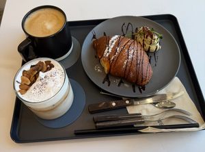 (clockwise from top left) Hot latte; matcha croissant, specialty almond latte  at Nuldam Space - 널담은공간 경복궁점 in Seoul