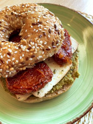 Bagel with vegan pesto, marinated tofu and dry tomato at O Ninho Family Bar in Lagos