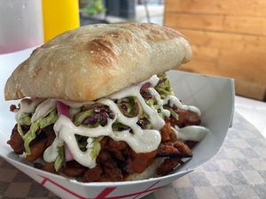 Maple Chipotle Soy Curl sandwich on ciabatta, cilantro lime slaw, cashew crema and pickled red onions.  at Sammies in Bellingham