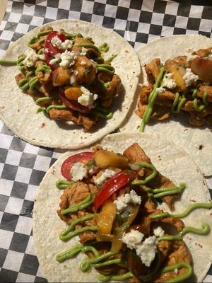 Heirloom Tomato & Grilled Peach Taco Special: roasted soy curls, avocado puree, almond cotija cheese, grilled peaches and nectarines, heirloom cherry tomatoes. at Sammies in Bellingham