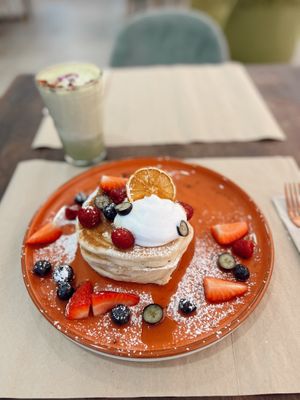 Fluffy American Pancakes with maple syrup and fresh seasonal fruits   at Puravita Vegan  in Estepona