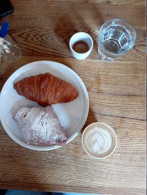 Cappuccino with oat milk, espresso, pistacchio croissant and empty croissant . at FREA Bakery in Berlin