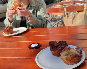 2 cardemom croissant, 1 Spandauer and one savory croissant being eaten. at FREA Bakery in Berlin