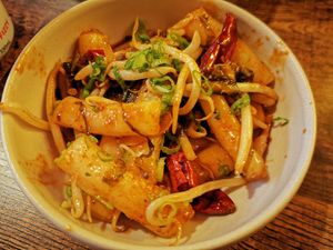 Chilli drive cakes, wok fried with pickles, smoky dry chili, garlic and homemade sauce at The Real Wan in Glasgow