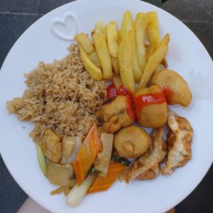 Fried rice, chips, sweet n sour chicken, dumplings and water chestnuts with tofu and bamboo shoots at Vegan House in Pudsey