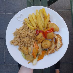 Fried rice, chips, sweet n sour chicken, dumplings and water chestnuts with tofu and bamboo shoots at Vegan House in Pudsey