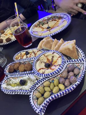 Fatima’s plate, one “finger” is labneh (not vegan). Hummus plates with falafel & chickpea salad  at Arabeska in Bratislava