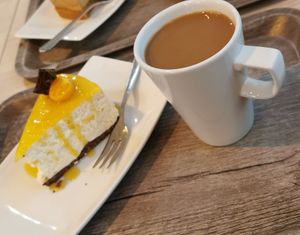 Mango cake and coffee at Cake House Café in Tampere