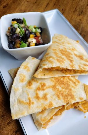 Buffalo chickpea quesadillas with vegan cheese. This cheese could be used elsewhere. Also a nice red pepper walnut dip on menu now at Alloy Kitchen in Bellefonte