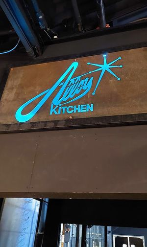 Sign outside says Titan Hollow, and staff shirts say Mad McIntosh at Alloy Kitchen in Bellefonte