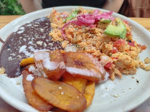 Huevos mexicanos with fried plátanos, beans and vegan almond "cheese" at Hierba Santa in Tuxtla Gutierrez