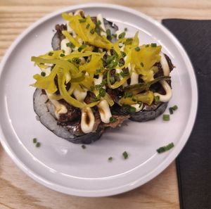 vegetable kimbap volcano roll: kimchi kimbap roll topped with pulled shiitake mushroom, pickled pineapple, chives and mayo at Yo! Sushi - Trafford in Manchester