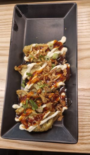 mega korean gyoza vegetable: Veggie gyoza topped with Korean ketchup, shichimi, mayo, crispy & spring onions at Yo! Sushi - Trafford in Manchester