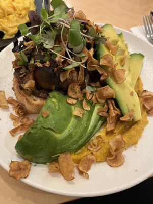 Sautéed mushrooms on toast with extra side avocado  at Ten Square Cafe in Melbourne
