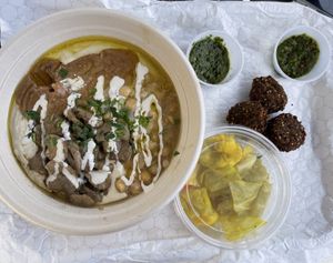 Vegan gluten free warm hummus bowl with mushrooms & chickpeas, falafel, zhug, and pickles. Just request no egg and they can sub falafel or something else.I requested no pita too    at Hummus Lali in Westlake Village