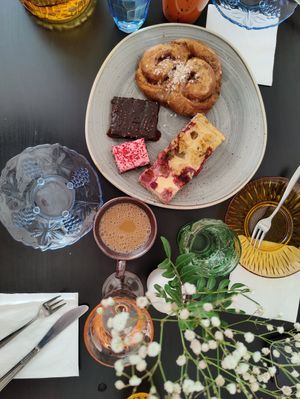 Selection of deserts to share, moist rhubarb pie, liquorice-rasberry cake, perfectly made cinnamon bun, chocolate cake with sea salt at Kahvila Rakastan in Helsinki