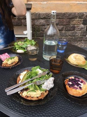 Lunch plate with salad and two Karelian pies with different toppings  at Kahvila Rakastan in Helsinki
