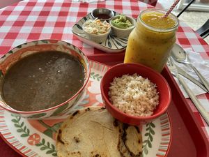 Sopa negra, pupusa, jugo de mango y maracuyá  at Sopitas in San Jose