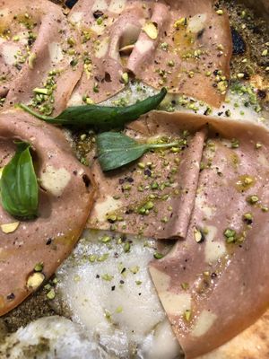 Vegan mortadella, rice mozzarella, and pistachio cream pizza at Assaje in Turin