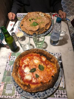 Top pizza is vegan. It's pistachio pesto, vegan cheese and mock meat. at Assaje in Turin