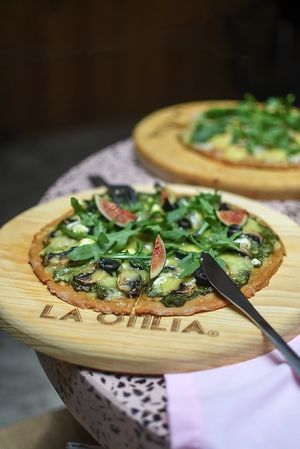 Variety of pizzas with vegan bases made of chickpeas or almond/cauliflower and you can change to vegan cheese. Add vegan chorizo for more taste.  at La Otilia - Polanco in Mexico City
