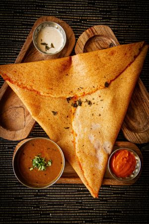 Palakkadan Dosa (rice and lentil fermented crepe spread with medium spicy chutney) and Sambar ( lentil based vegetable stew), tomato chutney and coconut chutney. at Malayalam in Eastbourne
